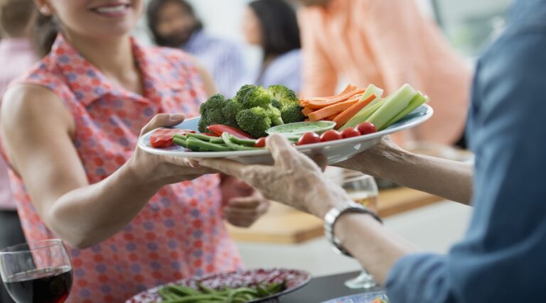 Groups of people,USA,An open plan office in New York City. A working lunch, a salad buffet. A group of men and women of mixed ages and ethnicities meeting together.