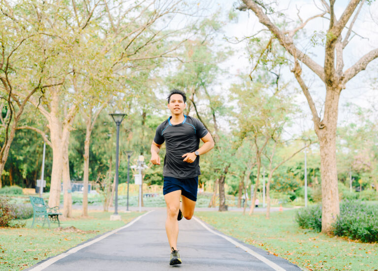healthy Asian man running in the park in morning