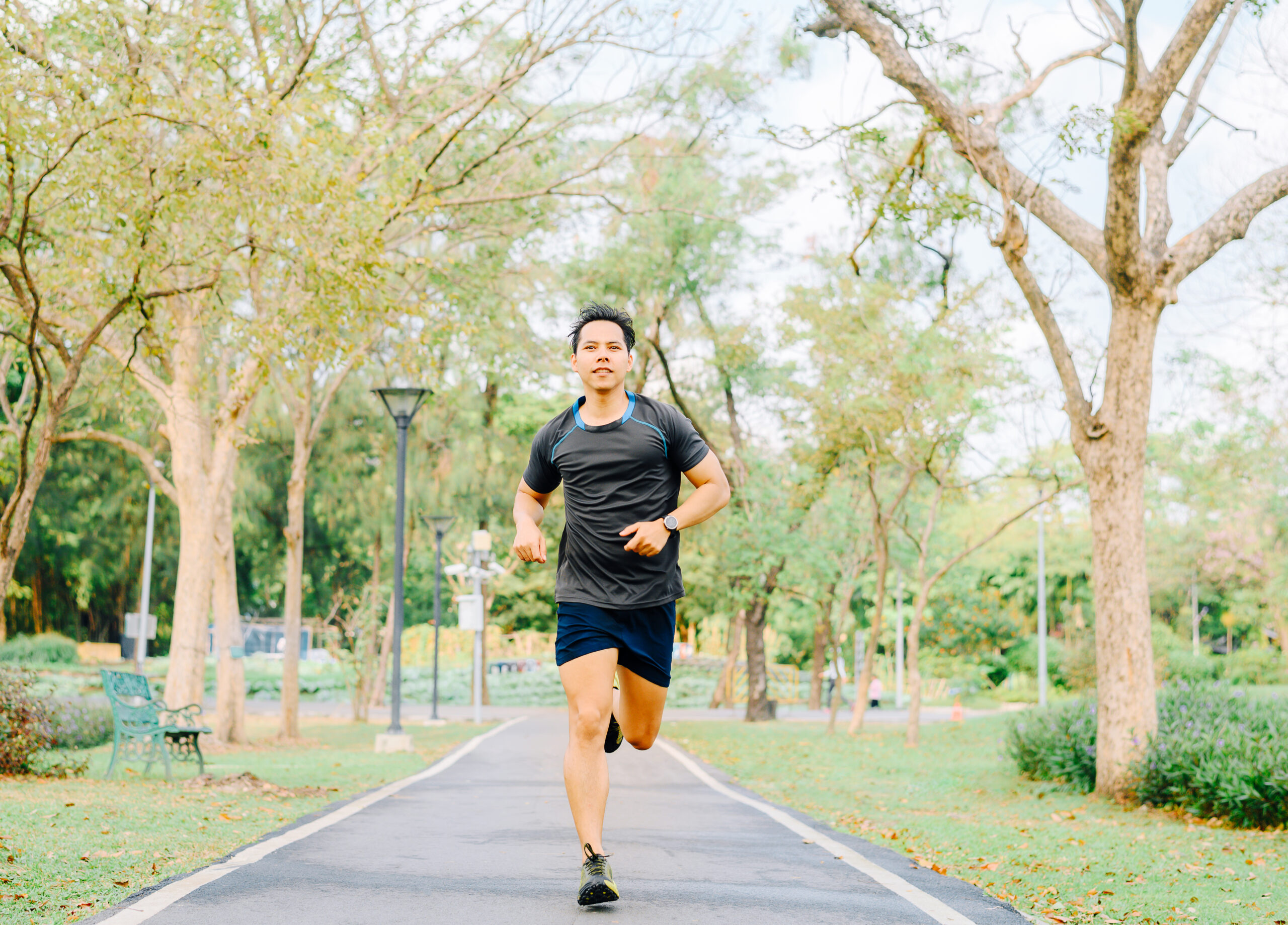 healthy Asian man running in the park in morning